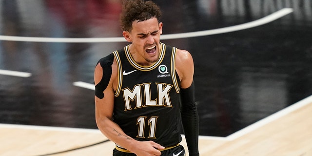 Atlanta Hawks' Trae Young reacts after he scores during the second half of Game 4 of a second-round NBA basketball playoff series against the Philadelphia 76ers on Monday, June 14, 2021, in Atlanta. (AP Photo/Brynn Anderson)