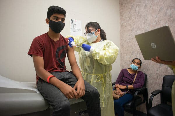A 14-year-old receiving Moderna’s Covid vaccine in February during a clinical trial in Houston.