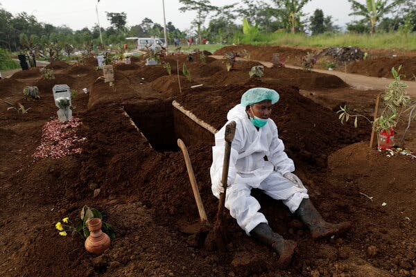 A gravedigger rested after the burial of a Covid victim in Bogor, West Java province, Indonesia, earlier this month. Indonesia is struggling to cope with a devastating wave of cases driven by the Delta variant.