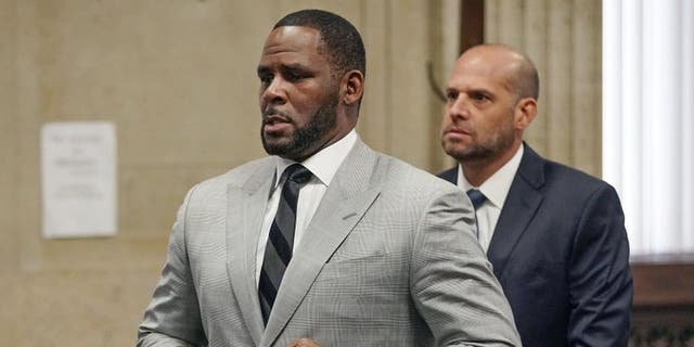 In this June 6, 2019, file photo, singer R. Kelly pleaded not guilty to 11 additional sex-related felonies during a court hearing before Judge Lawrence Flood at Leighton Criminal Court Building in Chicago. (E. Jason Wambsgans/Chicago Tribune via AP, Pool)