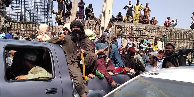 Taliban fighters sit on a vehicle along the street in Jalalabad province on Aug, 15, 2021. (AFP via Getty Images)
