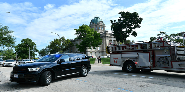 Kankakee Police and fire blockade the area of East Merchant Street following a shooting near the Kankakee County Courthouse, Thursday morning, Aug. 26, 2021, in Kankakee, Ill. Two people were killed and another was injured Thursday morning, Mayor Christopher Curtis said.