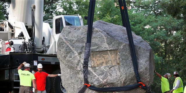 Crews work to remove Chamberlin Rock from Observatory Hill on UW-Madison campus in Madison, Wis., Friday, Aug. 6, 2021. The University of Wisconsin is removing the 70-ton boulder from its Madison campus at the request of minority students who view the rock as a symbol of racism. Chamberlin Rock, on the top of Observatory Hill, is named after Thomas Crowder Chamberlin, a geologist and former university president.     (Kayla Wolf/Wisconsin State Journal via AP)