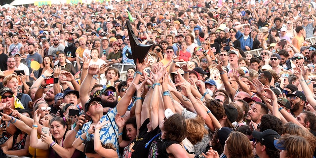 CHICAGO, ILLINOIS - JULY 31:  Crowd catches Wes Borland's guitar during Lollapalooza 2021 at Grant Park on July 31, 2021 in Chicago, Illinois. (Photo by Kevin Mazur/Getty Images)