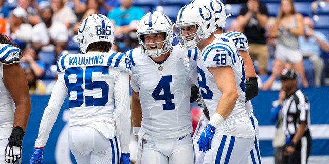 Indianapolis Colts quarterback Sam Ehlinger (4) celebrates after a two-point conversion against the Carolina Panthers during the second half of an NFL football game in Indianapolis, Sunday, Aug. 15, 2021. (AP Photo/AJ Mast)
