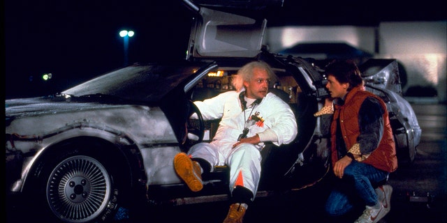 This photo provided by Universal Pictures Home Entertainment shows Christopher Lloyd, left, as Dr. Emmett Brown, and Michael J. Fox as Marty McFly in the 1985 film, ‘Back to the Future.’