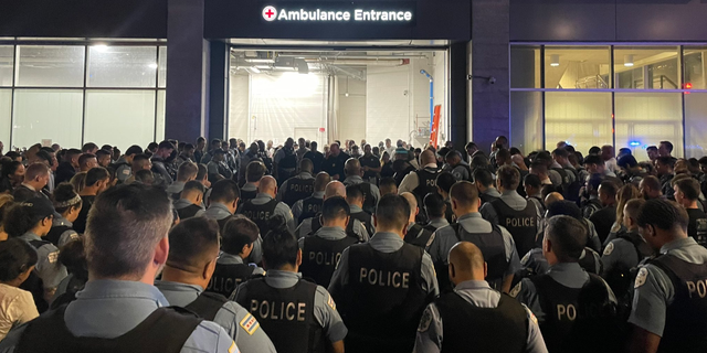 Chicago police officers gather overnight outside the University of Chicago Medical Center, where one officer died and another remained hospitalized after Saturday's shooting incident. (Chicago Police)