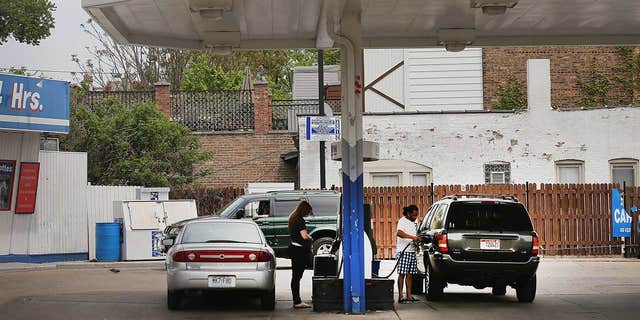 Customers purchase gasoline at a Marathon gas station in Chicago, Illinois. 