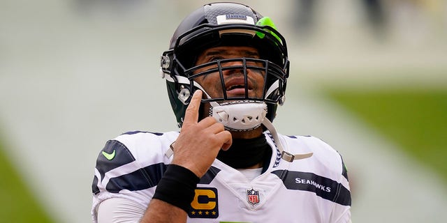 Seattle Seahawks quarterback Russell Wilson (3) points upward before the start of the first half of an NFL football game against the Washington Football Team, Sunday, Dec. 20, 2020, in Landover, Md. (AP Photo/Andrew Harnik)