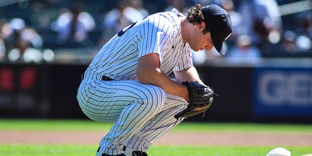 New York Yankees pitcher Gerrit Cole kneels before the start of the game against the Cleveland Indians at Yankee Stadium.