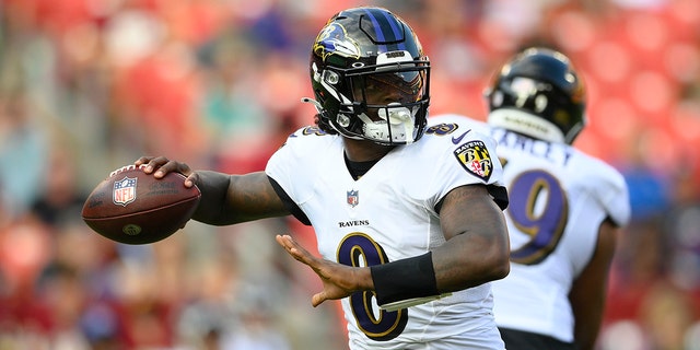Baltimore Ravens quarterback Lamar Jackson looks downfield before throwing the ball against the Washington Football Team during the first half of a preseason NFL football game, Saturday, Aug. 28, 2021, in Landover, Md. (AP Photo/Nick Wass)