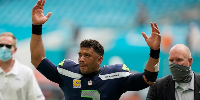 Seattle Seahawks quarterback Russell Wilson reacts to cheering fans at the end of an Oct. 4, 2020 game in Miami Gardens, Fla. The Seahawks defeated the Dolphins 31-23. (AP Photo/Wilfredo Lee)