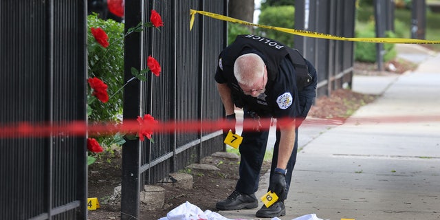 Chicago Police investigate a crime scene where three people were shot at the Wentworth Gardens housing complex in the Bridgeport neighborhood on June 23. The city reported 78 murders in August, a 22% jump compared to August 2020, the Chicago Police Department said Wednesday. (Photo by Scott Olson/Getty Images)