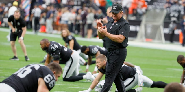 Head coach Jon Gruden of the Las Vegas Raiders talks to his players as they stretch before a game against the Chicago Bears at Allegiant Stadium on October 10, 2021 in Las Vegas, Nevada. The Bears defeated the Raiders 20-9. 