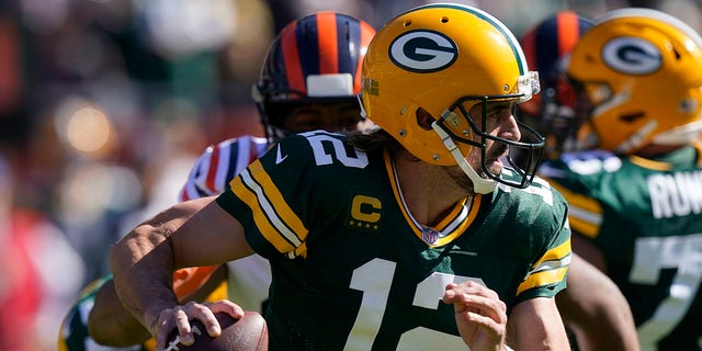 Green Bay Packers quarterback Aaron Rodgers scrambles during the first half of an NFL football game against the Chicago Bears Sunday, Oct. 17, 2021, in Chicago. (AP Photo/Nam Y. Huh)