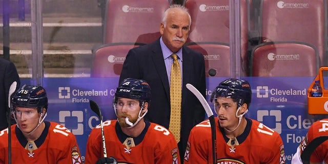 Florida Panthers head coach Joel Quenneville looks on from the bench during the first period of an NHL hockey game against the Colorado Avalanche, Tuesday, Oct. 21, 2021, in Sunrise, Florida.