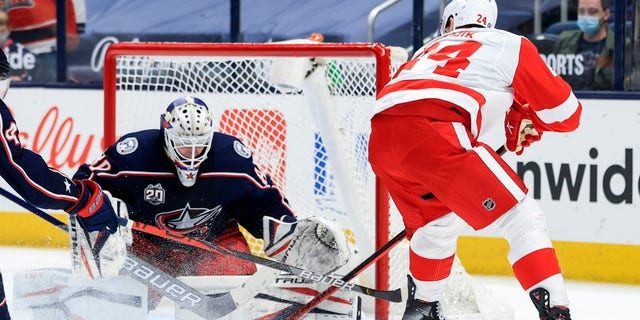 Columbus Blue Jackets goaltender Matiss Kivlenieks (80) makes a save in net against Detroit Red Wings right wing Richard Panik (24) in the overtime period May 8, 2021, at Nationwide Arena in Columbus, Ohio.