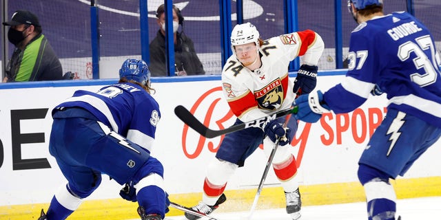 Florida Panthers right wing Owen Tippett (74) skates with the puck as Tampa Bay Lightning defenseman Mikhail Sergachev (98) defends during the second period during game six of the first round of the 2021 Stanley Cup Playoffs on May 26, 2021, at Amalie Arena in Tampa, Florida.