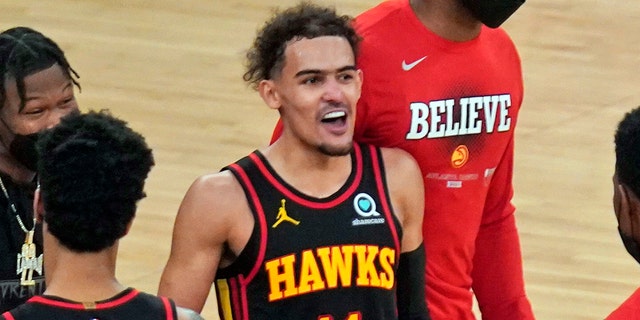 Atlanta Hawks' Trae Young (11) and the rest of his teammates celebrate after Game 1 of an NBA basketball first-round playoff series against the New York Knicks, Sunday, May 23, 2021, in New York. The Hawks defeated the Knicks, 107-105.