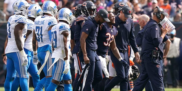 Chicago Bears running back David Montgomery (32) grimaces in pain as he leave the field after being injured during the second half of an NFL football game against the Detroit Lions Sunday, Oct. 3, 2021, in Chicago.
