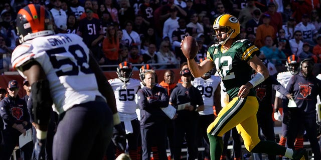 Green Bay Packers quarterback Aaron Rodgers pulls the ball down and runs for a touchdown during the second half of an NFL football game against the Chicago Bears Sunday, Oct. 17, 2021, in Chicago.