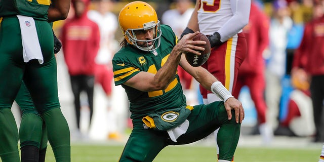 Green Bay Packers' Aaron Rodgers celebrates his first down run during the first half of an NFL football game against the Washington Football Team Sunday, Oct. 24, 2021, in Green Bay, Wis.