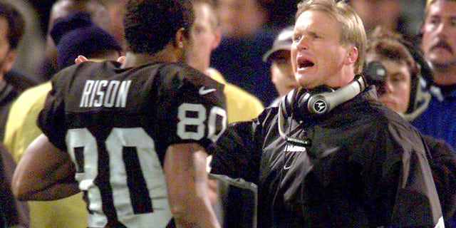 Oakland, CA December 10, 2000: Raiders coach Jon Gruden talks with Andre Rison during a rout of the Jets. 