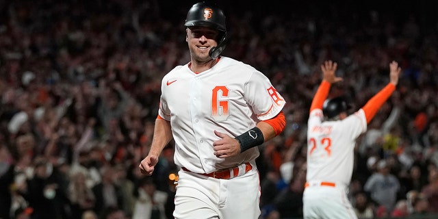 San Francisco Giants' Buster Posey runs home to score against the Los Angeles Dodgers during the eighth inning of a baseball game in San Francisco, Tuesday, July 27, 2021.