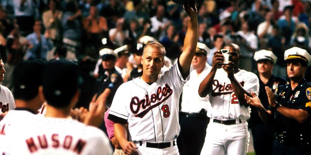 Infielder Cal Ripken Jr. of the Baltimore Orioles tips his cap to the fans after breaking Lou Gherig's record of 2130 consecutive games played on September 6, 1995 at Oriole Park at Camden Yards in Baltimore, Maryland.