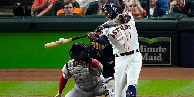 The Houston Astros' Carlos Correa hits a home run against the Boston Red Sox during the seventh inning of Game 1 of the American League Championship Series Friday, Oct. 15, 2021, in Houston. 