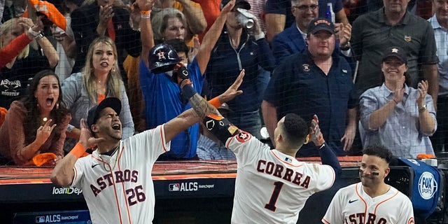 The Houston Astros' Carlos Correa celebrates a home run against the Boston Red Sox during the seventh inning in Game 1 of baseball's American League Championship Series Friday, Oct. 15, 2021, in Houston.