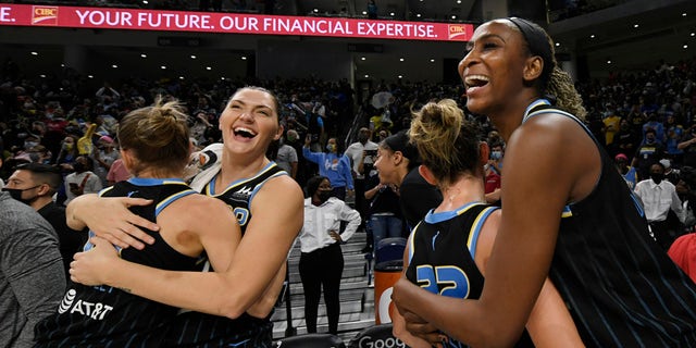 Chicago Sky's Astou Ndour-Fall, right, Courtney Vandersloot (22), Stefanie Dolson second from left, and Allie Quigley celebrate after the Sky defeated the Connecticut Sun 79-69 in Game 4 of a WNBA basketball semifinal series Wednesday, Oct. 6, 2021, in Chicago.