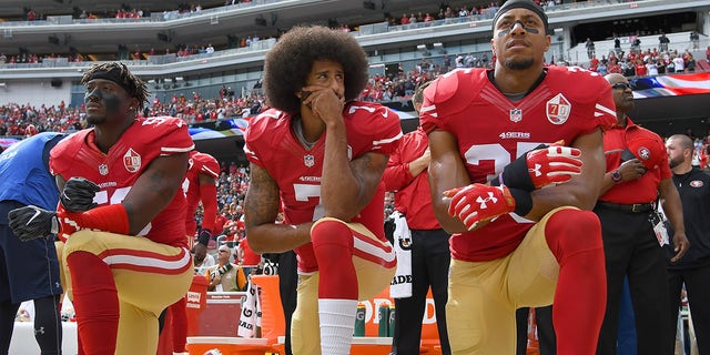 Colin Kaepernick #7 and Eric Reid #35 of the San Francisco 49ers kneel on the sideline during the National Anthem prior to the game against the Dallas Cowboys at Levi's Stadium on Oct. 2, 2016 in Santa Clara, California. 
