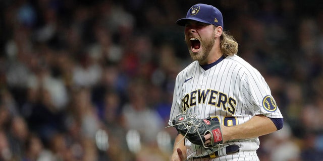 Milwaukee Brewers' Corbin Burnes reacts after striking out a batter during the seventh inning of a baseball game against the New York Mets Saturday, Sept. 25, 2021, in Milwaukee.