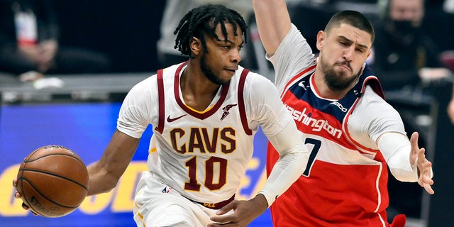 Cleveland Cavaliers guard Darius Garland (10) drives beside Washington Wizards center Alex Len (27) in the first quarter Apr 30, 2021, at Rocket Mortgage FieldHouse in Cleveland, Ohio.