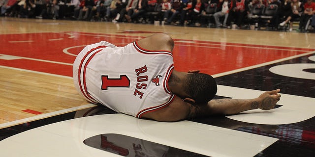 CHICAGO, IL - APRIL 28: Derrick Rose #1 of the Chicago Bulls lays on the floor aftrer suffering an injury against the Philadelphia 76ers in Game One of the Eastern Conference Quarterfinals during the 2012 NBA Playoffs at the United Center on April 28, 2012 in Chicago, Illinois. The Bulls defeated the 76ers 103-91.