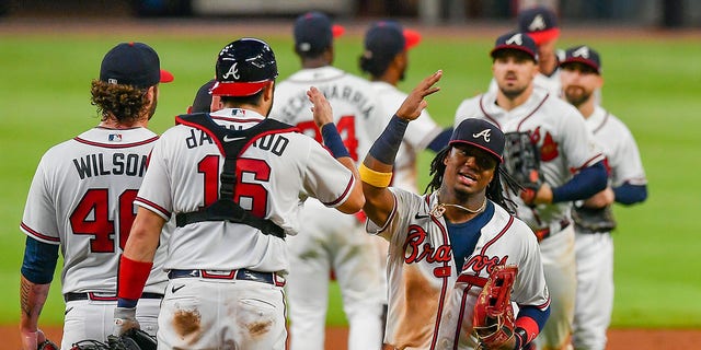 ATLANTA, GA  SEPTEMBER 09:  The Atlanta Braves players do "the chop" as they come off the field following the conclusion of the MLB game between the Miami Marlins and the Atlanta Braves on September 9th, 2020 at Truist Park in Atlanta, GA.