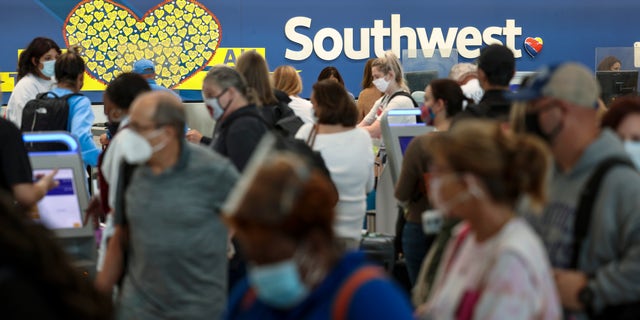 BALTIMORE, MARYLAND - OCTOBER 11: Travelers wait to check in at the Southwest Airlines ticketing counter at Baltimore Washington International Thurgood Marshall Airport on October 11, 2021 in Baltimore, Maryland. Southwest Airlines is working to catch up on a backlog after canceling hundreds of flights over the weekend, blaming air traffic control issues and weather. (Photo by Kevin Dietsch/Getty Images)