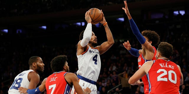 Derrick Rose (4) of the New York Knicks drives to the basket as Tobias Harris (12), Isaiah Joe (7), and Georges Niang (20) of the Philadelphia 76ers defend during the second half at Madison Square Garden Oct. 26, 2021 in New York City. 