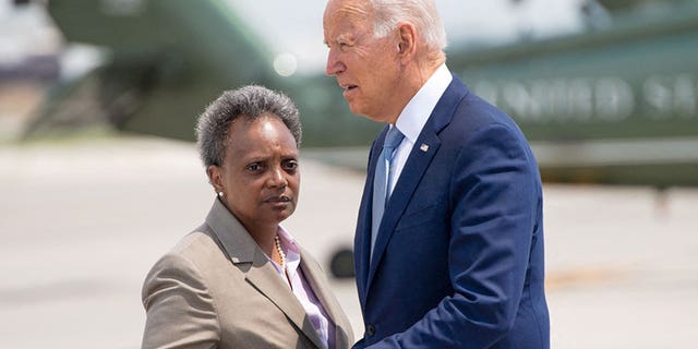 President Biden greets Chicago Mayor Lori Lightfoot as he disembarks from Air Force One upon arrival at O'Hare International Airport in Chicago, Illinois, July 7, 2021.