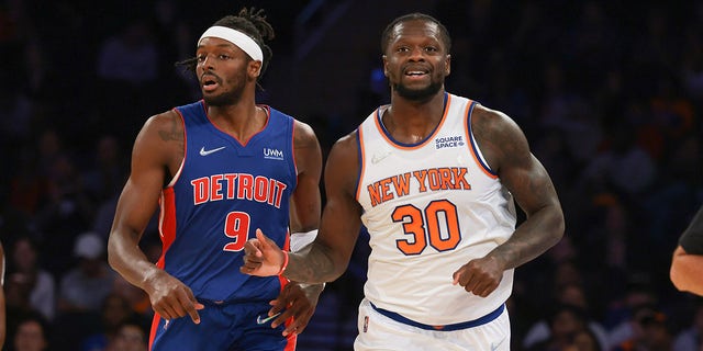 New York Knicks forward Julius Randle (30) runs up court after scoring a basket alongside Detroit Pistons forward Jerami Grant (9) during the first half Oct 13, 2021, at Madison Square Garden in New York.
