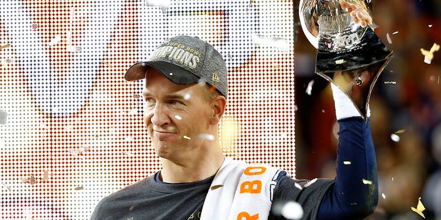 Denver Broncos' quarterback Peyton Manning holds the Vince Lombardi Trophy after the Broncos defeated the Carolina Panthers in the NFL's Super Bowl 50 football game in Santa Clara, California, Feb. 7, 2016.