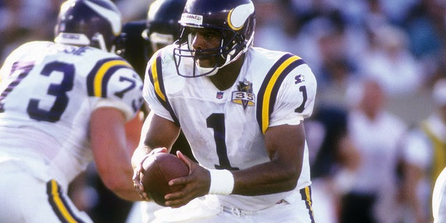 Quarterback Warren Moon of the Minnesota Vikings turns to hand the ball off to a running back against the Chicago Bears during an NFL football game Sept. 3, 1995, at Soldier Field in Chicago, Illinois. Moon played for the Vikings from 1994-96.