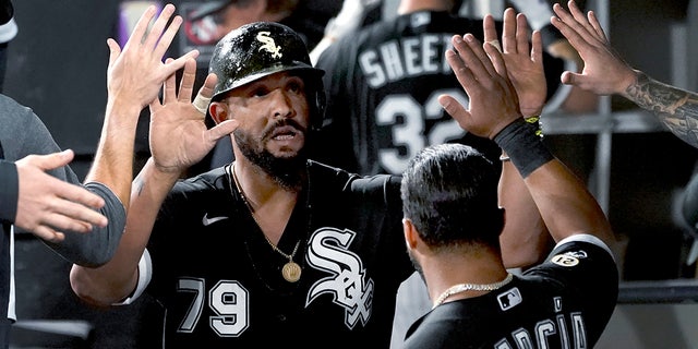 Chicago White Sox's Jose Abreu is congratulated in the dugout after scoring on a single by Yasmani Grandal during the sixth inning of the team's baseball game against the Los Angeles Angels on Wednesday, Sept. 15, 2021, in Chicago. 