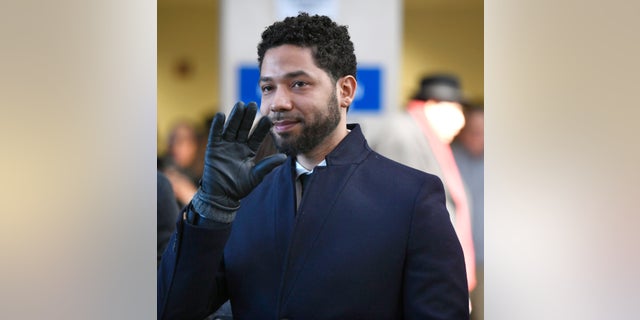 FILE - Actor Jussie Smollett smiles and waves to supporters before leaving Cook County Court after his charges were dropped Tuesday, March 26, 2019, in Chicago. Smollett is going on trial this week, accused of lying to police when he reported he was the victim of a racist, homophobic attack downtown Chicago nearly three years ago. Jury selection is scheduled for Monday, Nov. 29, 2021. (AP Photo/Paul Beaty, File)