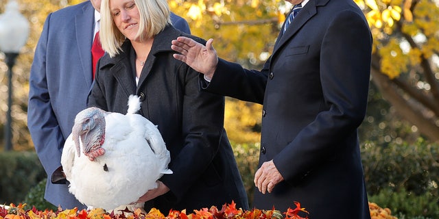 U.S. President Joe Biden pardons the national Thanksgiving turkey, Peanut Butter, as Phil Seger, chairman of the National Turkey Federation, and Andrea Welp, a turkey grower from Indiana, stand by during the 74th National Thanksgiving Turkey Presentation in the Rose Garden at the White House in Washington, U.S., November 19, 2021. REUTERS/Jonathan Ernst