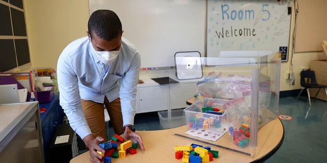 Bryant Elementary School kindergarten teacher Chris Johnson sets up his classroom on April 9, 2021 in San Francisco, California. (Photo by Justin Sullivan/Getty Images)