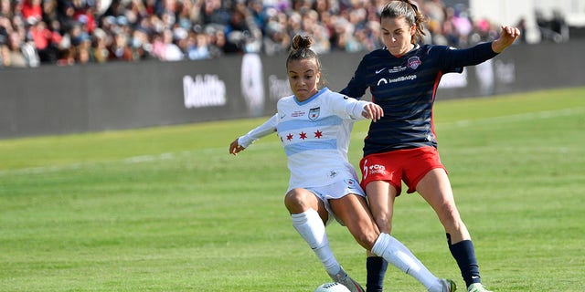 Washington Spirit defender Kelley O'Hara (5) battles Chicago Red Stars forward Mallory Pugh (9) for the ball during the NWSL Championship match at Lynn Family Stadium Nov 20, 2021, in Louisville, Ky. 