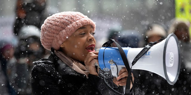 Kina Collins, a board member of the Illinois chapter of the Women's March, speaks as protestors gather in Federal Plaza for the Third Annual Women's March on Saturday, Jan. 19, 2019, in Chicago.
