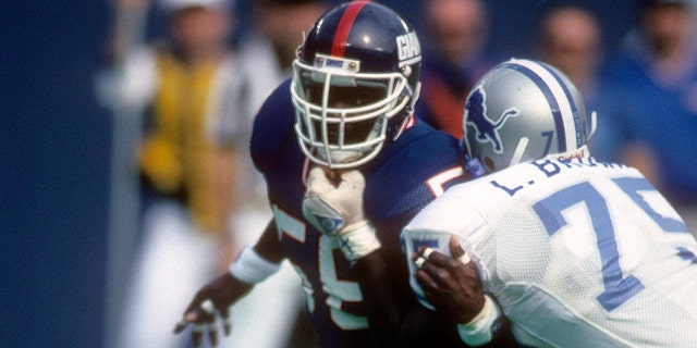 Linebacker Lawrence Taylor #56 of the New York Giants in action agains tackle Lomas Brown #75 of the Detroit Lions September 17, 1989 during an NFL football game at Giant Stadium in East Rutherford, New Jersey. Taylor played for the Giants from 1981-93.